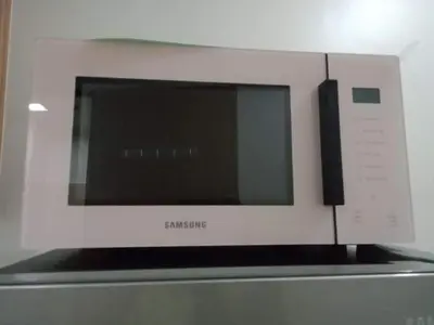 a microwave oven sitting on top of a refrigerator at Shore Residence Tower 1 Staycation in Manila