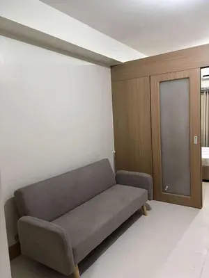 a living room with a couch in a room at Shore Residence Tower 1 Staycation in Manila