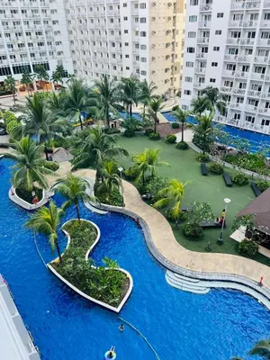 an aerial view of a resort with palm trees and a pool at Apartment Rm# 839 B shore 1 in Manila