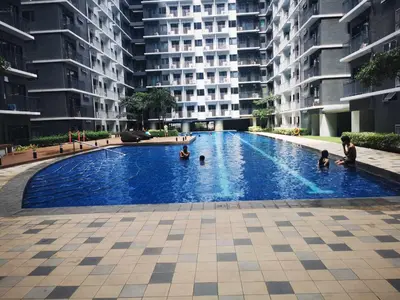 a group of people in a swimming pool in a building at Shore 3 tower 2 mall of Asia staycation in Manila