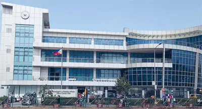 a large building with a flag in front of it at Mall Of Asia - Shore Apartments in Manila