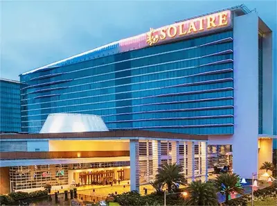 a large building with a sign on top of it at Mall Of Asia - Shore Apartments in Manila
