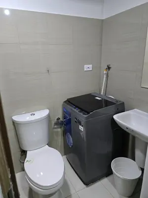 a small bathroom with a toilet and a sink at Mall Of Asia - Shore2 Residences in Manila