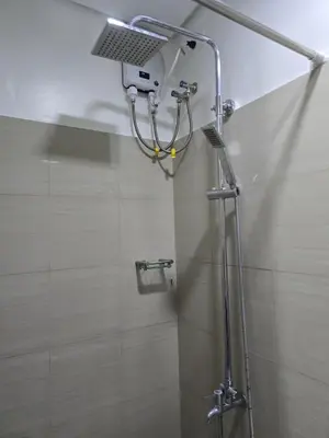a shower with a shower head in a bathroom at Mall Of Asia - Shore2 Residences in Manila