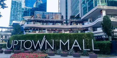 a sign in front of a downtown mall with buildings at SMDC Apartment in FAME in Manila