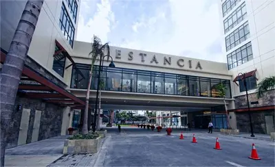a building with a walkway with orange cones in front of it at SMDC Fame Condo in Manila