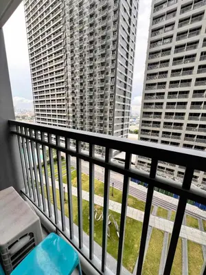 a balcony with a view of two tall buildings at SMDC Fame Residences in Manila