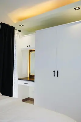 a bedroom with a bed and a door with a mirror at Serene Stays at Shore in Manila