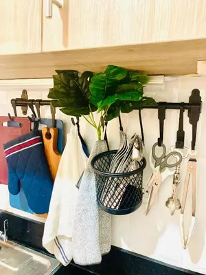 a kitchen counter with a plant in a basket on the sink at Serene Stays at Shore in Manila