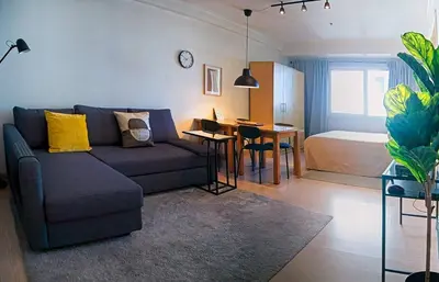a living room with a couch and a bedroom at Private Modern Condo in BGC in Manila