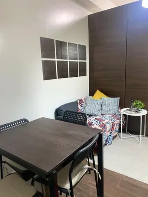 a living room with a table and a couch at Casa Beatrice Staycation in Manila