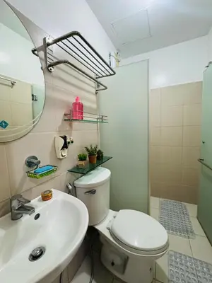 a bathroom with a toilet and a sink at Casa Lily in Manila