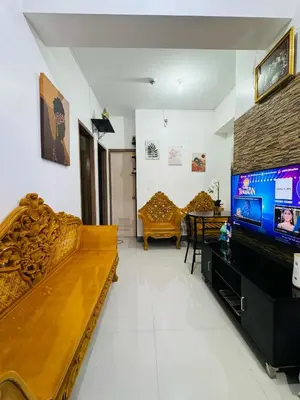 a living room with a couch and a flat screen tv at Casa Lily in Manila