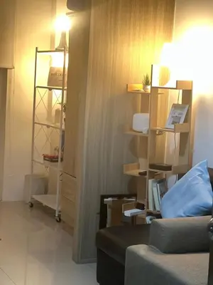a living room with a couch and some shelves at 1BR Room-Stunning MOA view FIREWORKS in Manila