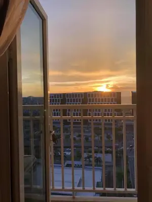 a view of the sunset from the balcony of a building at 1BR Room-Stunning MOA view FIREWORKS in Manila