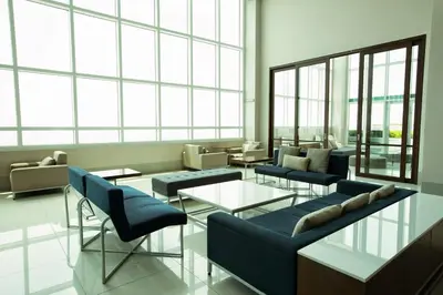 a living room with couches and tables and windows at Tower 1 Rm 305 FREE Parking, FREE Pool, Balcony, 1Bedroom 4 beds in Manila
