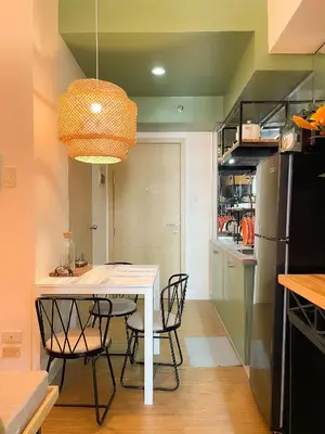 a dining room with a white table and chairs at Houzz 845 by Houzztelity in Manila