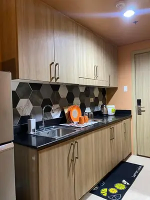 a kitchen with a sink and a counter top at COZY PASAY CONDOMINIUM HOTEL UNIT with NETFLIX in Manila