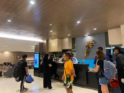 a group of people standing around in an airport at COZY PASAY CONDOMINIUM HOTEL UNIT with NETFLIX in Manila