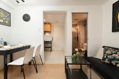 a living room with a couch and a table at Tranquil Greenbelt Makati Condo - Free Pool Access in Manila