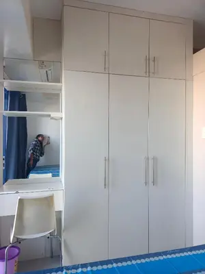 a man taking a picture of a white cabinet in a room at Sea Residence Tower EF by Theresa P in Manila