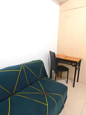 a bedroom with a bed and a desk with a table at Sea Residences - Jan 0976-206-7884 in Manila