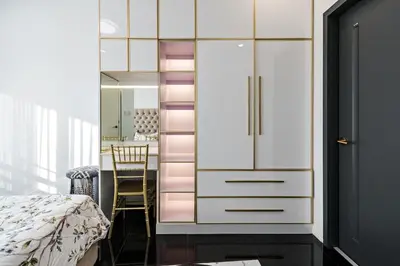 a bedroom with a white cabinet and a table at Makati City Centre Condo in Manila