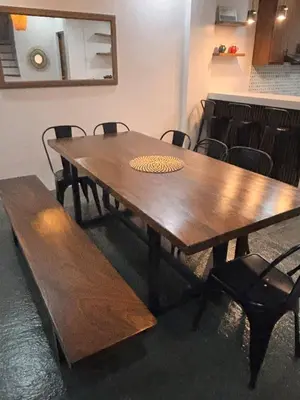 a wooden table and benches in a room at Villa Serene Resort in General Trias