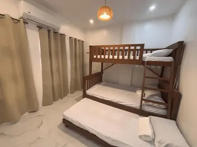 a room with two bunk beds and a lamp at Villa Serene Resort in General Trias