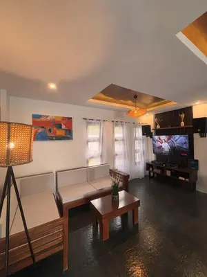 a living room with a couch and a tv at Villa Serene Resort in General Trias