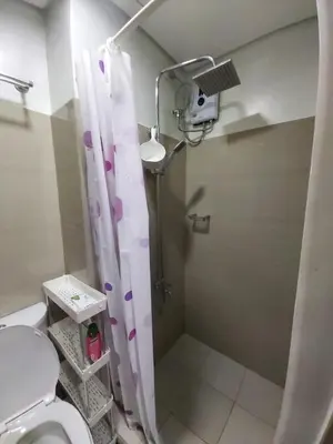 a bathroom with a shower and a toilet at Chic Urban Retreat near mall of asia in Manila