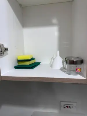 a shelf with some towels and a pot on it at Shore 2 Tower 3 Chic and Cozy by Richnells in Manila