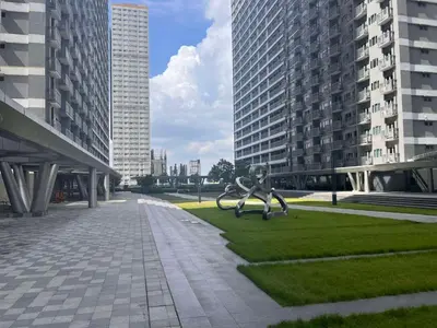 a statue of a boy on a playground in a city at Ortigas Business District Prime Accommodations in Manila