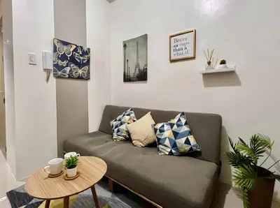 a living room with a couch and a table at Mall of Asia - Aseana Residences in Manila