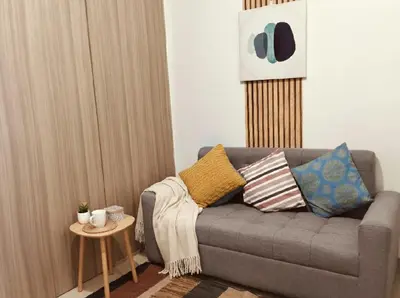 a living room with a couch and a table at Mall of Asia - Aseana Residences in Manila