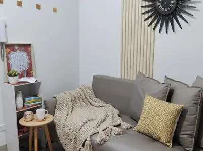 a living room with a gray couch and a table at Mall of Asia - Aseana Residences in Manila