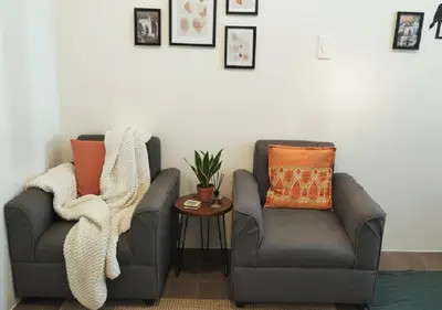 two chairs sitting next to each other in a room at Makati Business District Residences in Manila