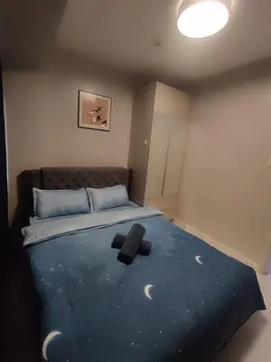 a bedroom with a large bed with the moon on it at Pool View BP1043 in Manila