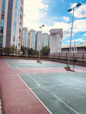 a tennis court in a city with tall buildings at Venetian Panorama BGC Venice Grand Canal Apart ment, 4 Bedrooms, for 10 Guests in Manila