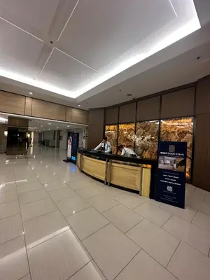 a lobby with a food counter in a building at Shell Residence Mall of Asia in Manila