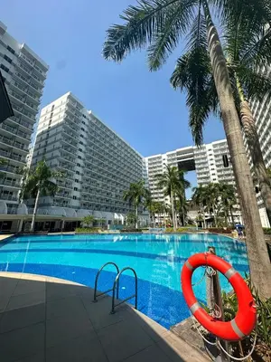 a swimming pool with a red float next to a building at Shell Residence Mall of Asia in Manila