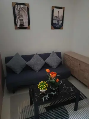 a living room with a blue couch and a table at SMDC Field REsidences condo unit in Manila