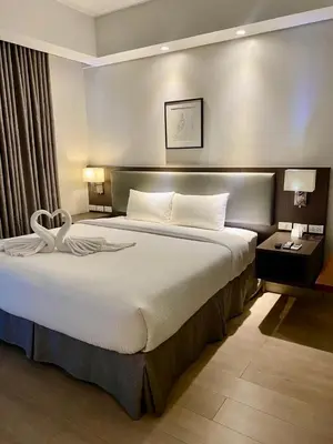 a bedroom with a large bed in a hotel room at Aura Luxe Stays at BCCT in Manila