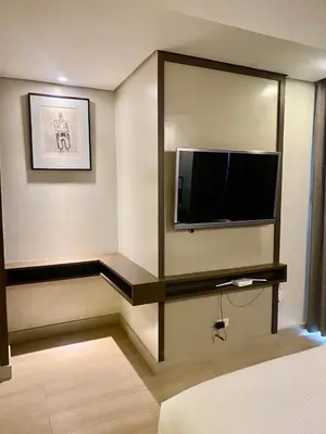 a room with a flat screen tv on a wall at Aura Luxe Stays at BCCT in Manila