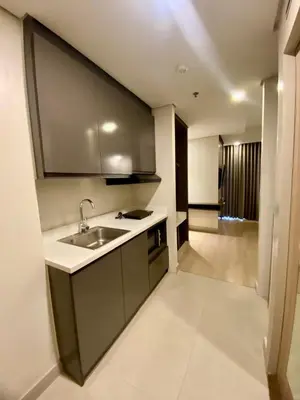 a kitchen with a sink and a counter top at Aura Luxe Stays at BCCT in Manila