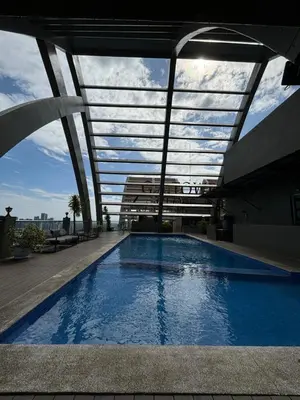 a swimming pool on the roof of a building at Trendy 3BR Loft Condo along EDSA in Manila