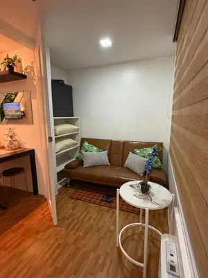 a living room with a couch and a table at Trendy 3BR Loft Condo along EDSA in Manila