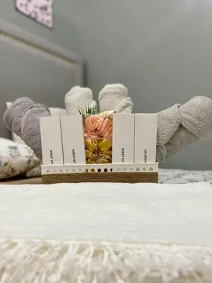 a box on a bed with flowers on it at Balay Hayahay Staycation in Manila