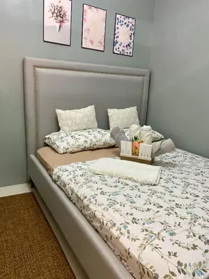 a bed with two boxes on it in a bedroom at Balay Hayahay Staycation in Manila