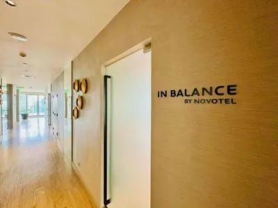 a hallway with a sign on the wall of a building at Novotel Executive Suite - Acqua Manila 2905 in Manila